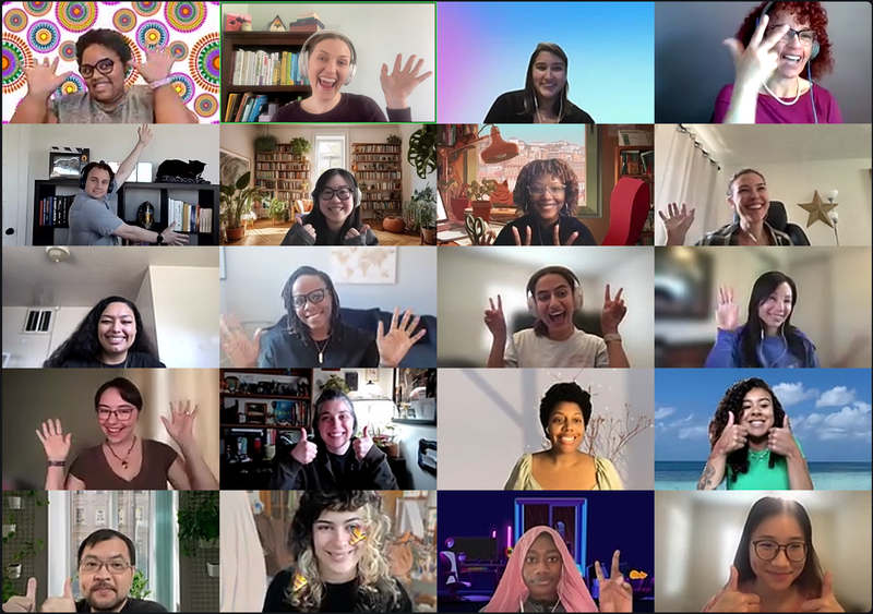 Organization-wide meeting attendees cheering with their hands up